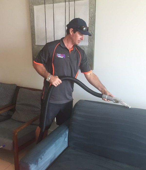 Worker Cleaning Upholstery — Steam Cleaning in Proserpine, QLD